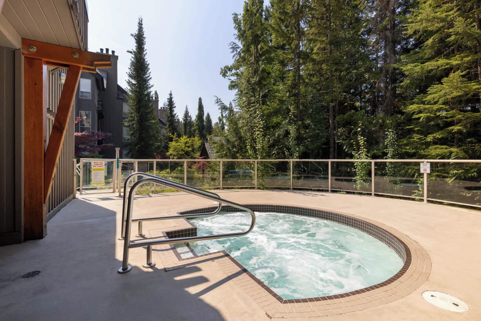 - Outdoor hot tub surrounded by tall evergreens for peaceful mountain relaxation  
- Perfect spot to soak and rejuvenate after skiing or hiking through scenic trails  
- Breathe in fresh alpine air while unwinding in your private bubbling spa retreat