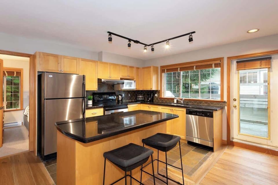 - Modern kitchen with black granite counters and stainless steel appliances  
- Fully stocked for every cooking need  
- Gather around the island for breakfast or evening drinks  