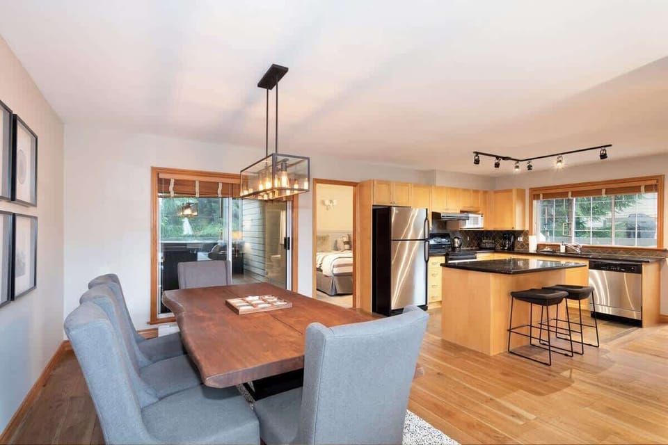 - Open dining and kitchen area filled with natural light and forest views  
- Wooden finishes add rustic mountain warmth  
- Ideal for shared meals and cozy mountain moments  