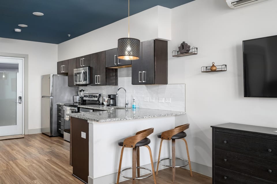 Modern kitchen with sleek appliances and cozy breakfast bar seating