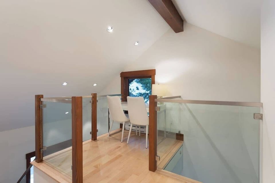 - Loft workspace with forest views and contemporary glass railing  
- Peaceful nook perfect for remote work or creative moments  
- Natural light and modern design enhance productivity  