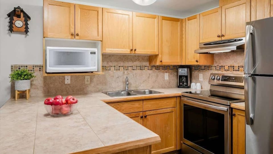 - Fully equipped kitchen with modern stainless design  
- Whistler condo featuring coffee maker and cozy charm  
- Cook your meals in comfort near ski and mountain fun  