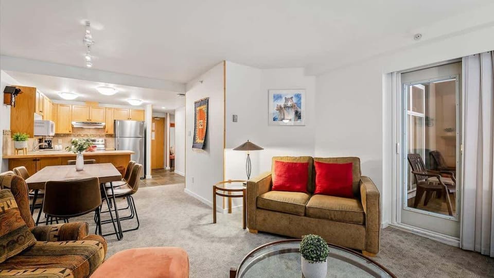 - Open living space with cozy sofa and mountain feel  
- Ideal Whistler family rental with full modern kitchen  
- Fireplace and comfort meet alpine design charm 