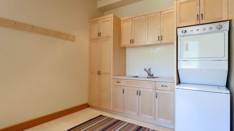 - Laundry room with washer, dryer, and ample storage cabinets  
- Functional space for extended stays and family convenience  
- Perfect for keeping clothes fresh during mountain adventures  

