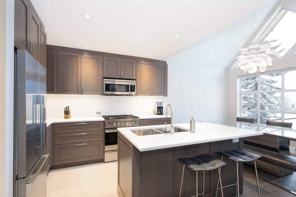 - Stylish kitchen with premium stainless appliances  
- Whistler vacation rental with island and breakfast bar  
- Perfect for cooking family meals after skiing adventures  

