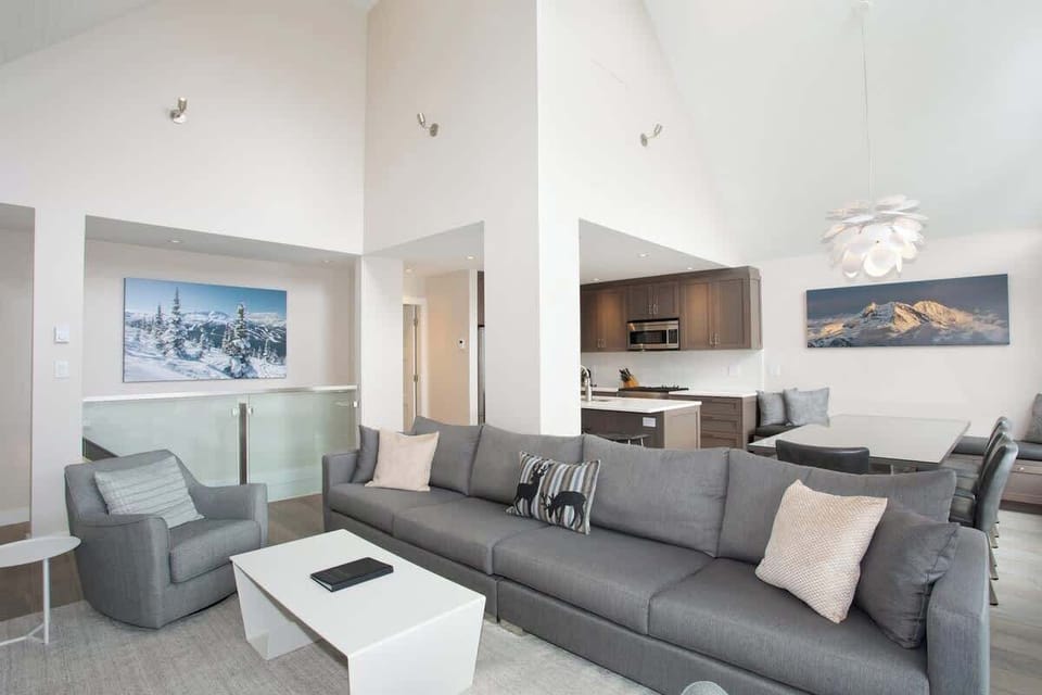 - Open-concept lounge and dining with mountain artwork  
- Whistler luxury retreat for families and ski groups  
- Warm inviting space steps from slopes and village shops  