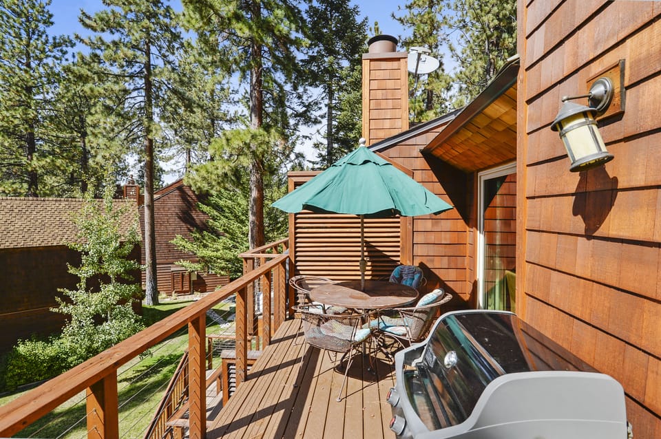 Upper Deck facing the lake with summer BBQ and outside furniture.