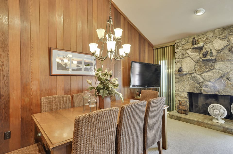 Open floor dining and living room with a flat screen TV and a fireplace!