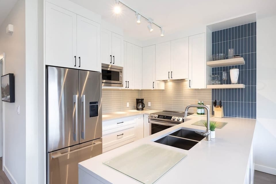 - Modern Whistler kitchen with stainless appliances  
- Fully equipped for gourmet mountain meal prep  
- Bright stylish design with sleek functional space  
