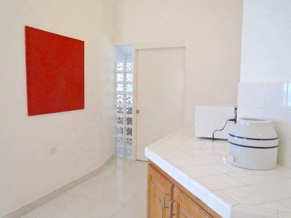 There is a small kitchen area upstairs with a microwave and sink