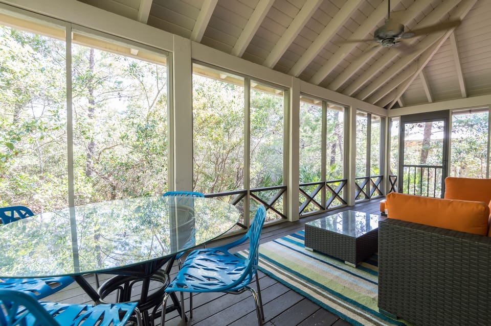 Enjoy the spacious screened porch surrounded by lush foliage. 