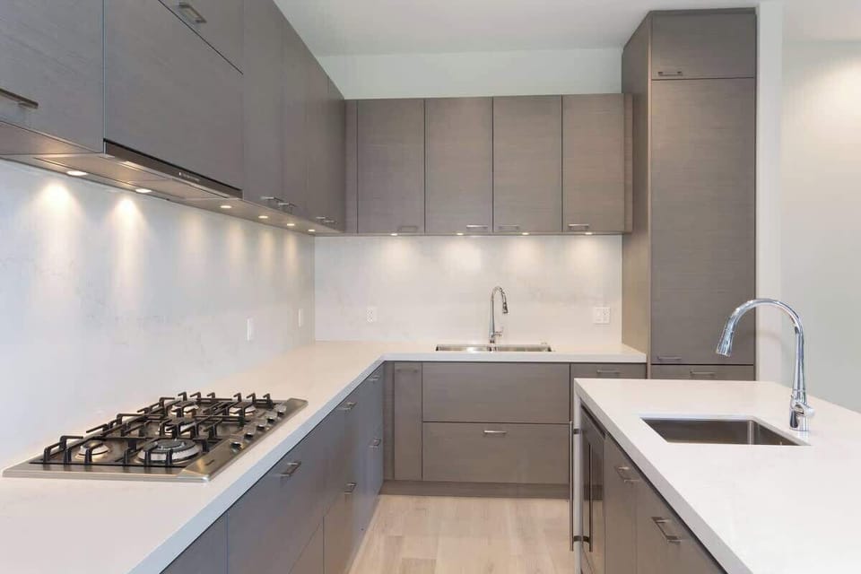 - Sleek kitchen with gray cabinetry and quartz countertops  
- Gas range and high-end finishes for a stylish cooking experience  
- Fully equipped for preparing meals with ease and comfort  
