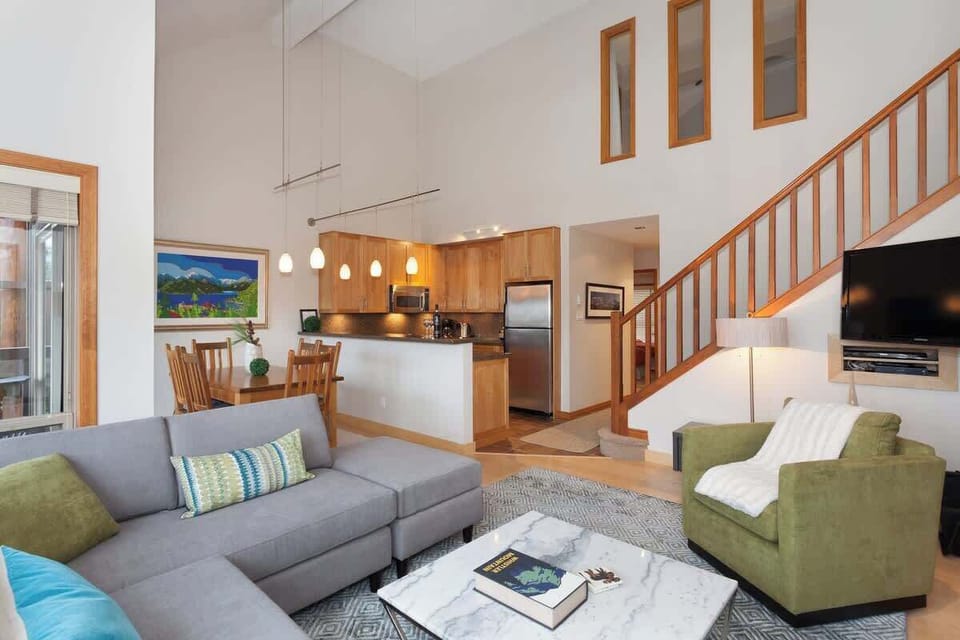 - Spacious open-concept living and kitchen area with high ceilings  
- Modern furnishings and soft color tones blend comfort and style  
- Ideal hub for socializing relaxing and sharing mountain memories  
