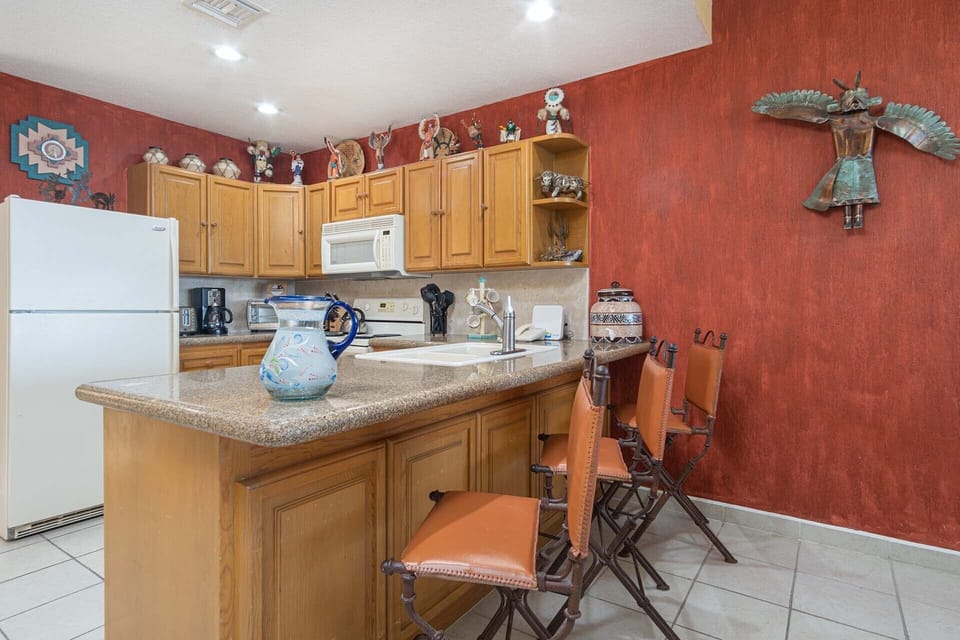 The kitchen counter with its bar stool style seating