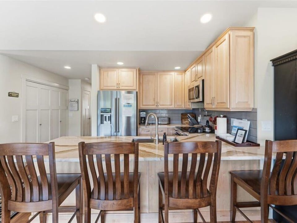 Your open kitchen and dining area offers warm wood tones, stainless appliances, and plenty of counter space for preparing meals together—perfect for morning coffee or evening gatherings.