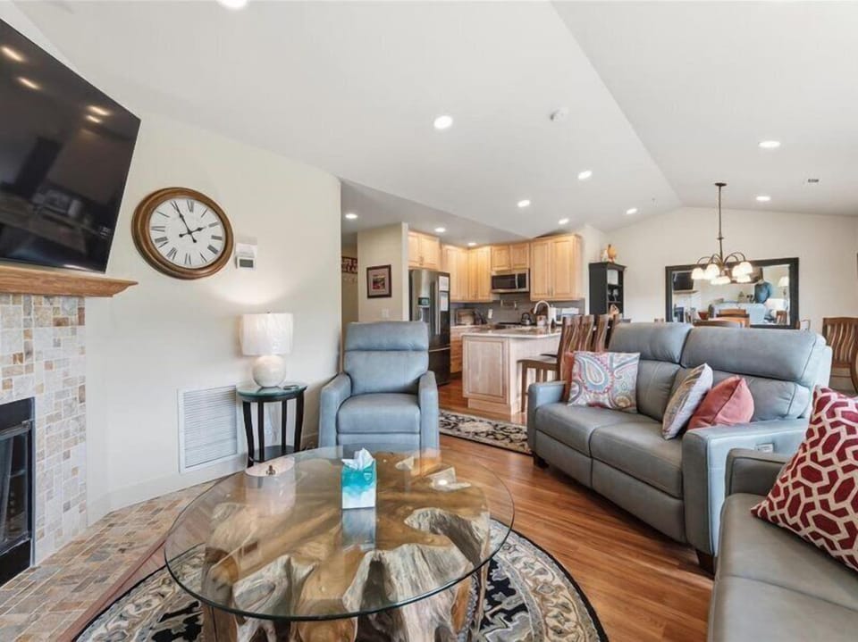 Relax in your open-concept living space with vaulted ceilings, plush seating, and a fully-equipped kitchen. Warm wood floors, modern amenities, and a cozy fireplace make this your perfect home base.