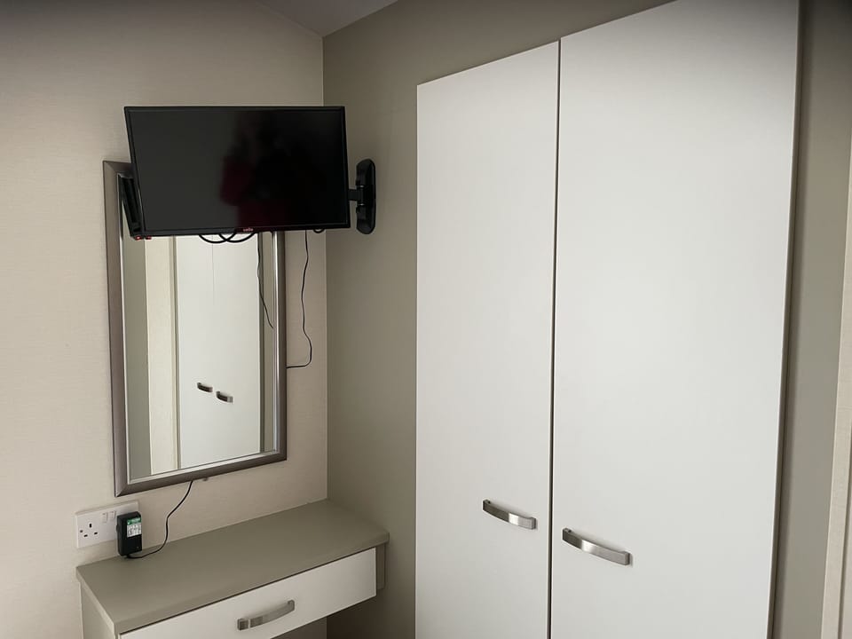 TV and wardrobe in main bedroom