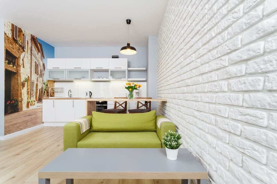 Another angle of the living room featuring the green sofa and a small coffee table.