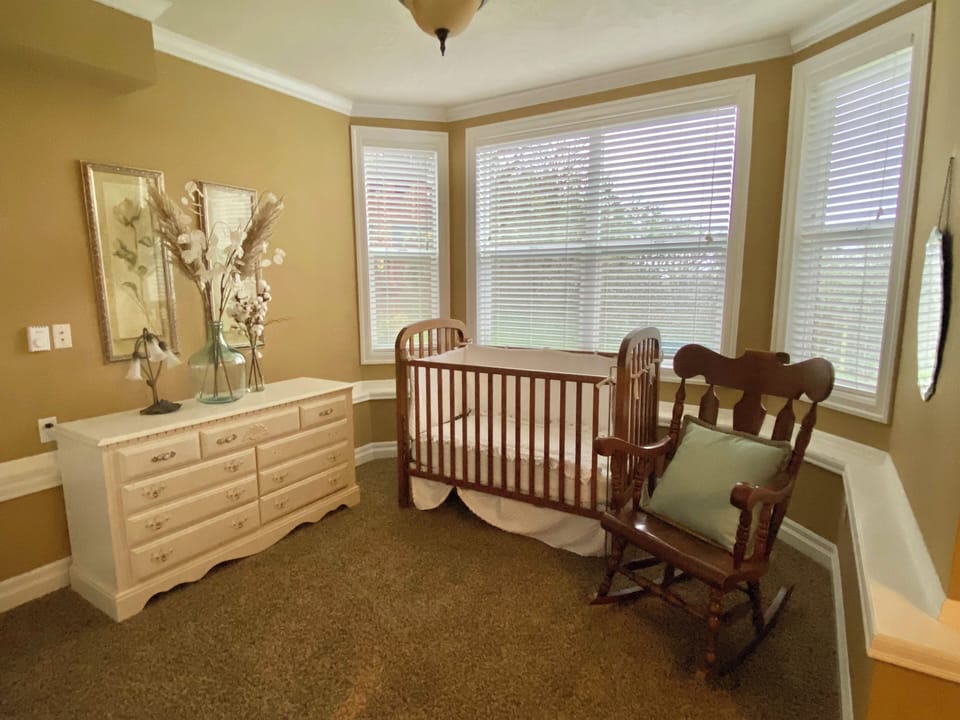 Sitting room with crib in the basement bedroom.