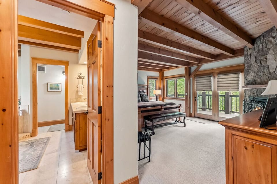 Main floor primary with private deck access, fireplace and ensuite bathroom