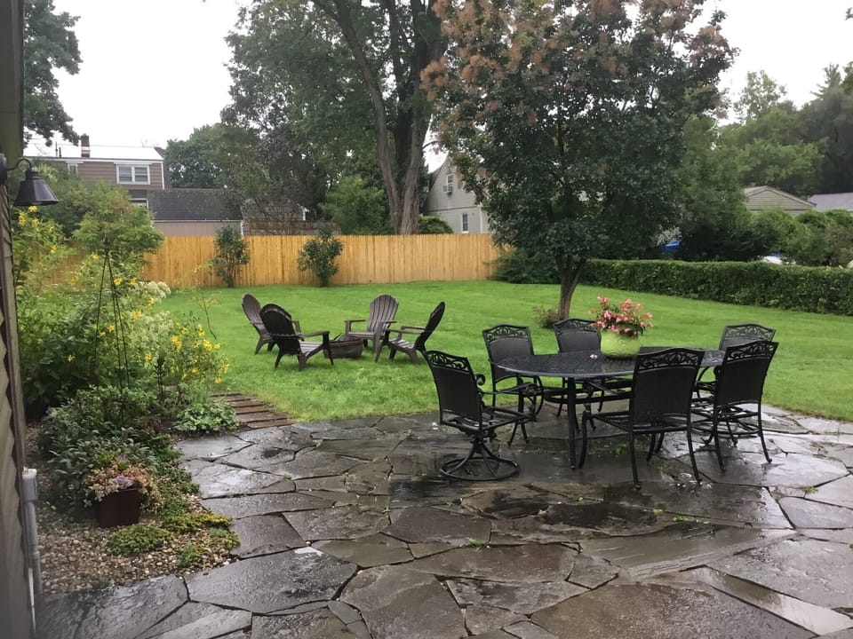 The back patio, fire pit, and a glimpse of my pollinator garden. 
