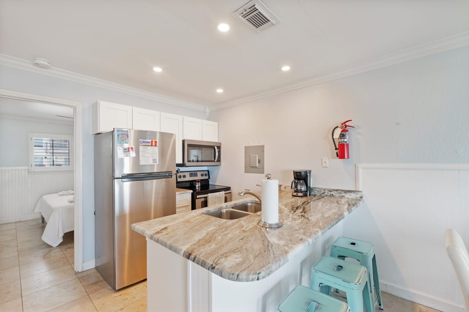 Your fully equipped kitchen awaits with granite counters, stainless appliances, and everything you need to create memorable meals during your stay.