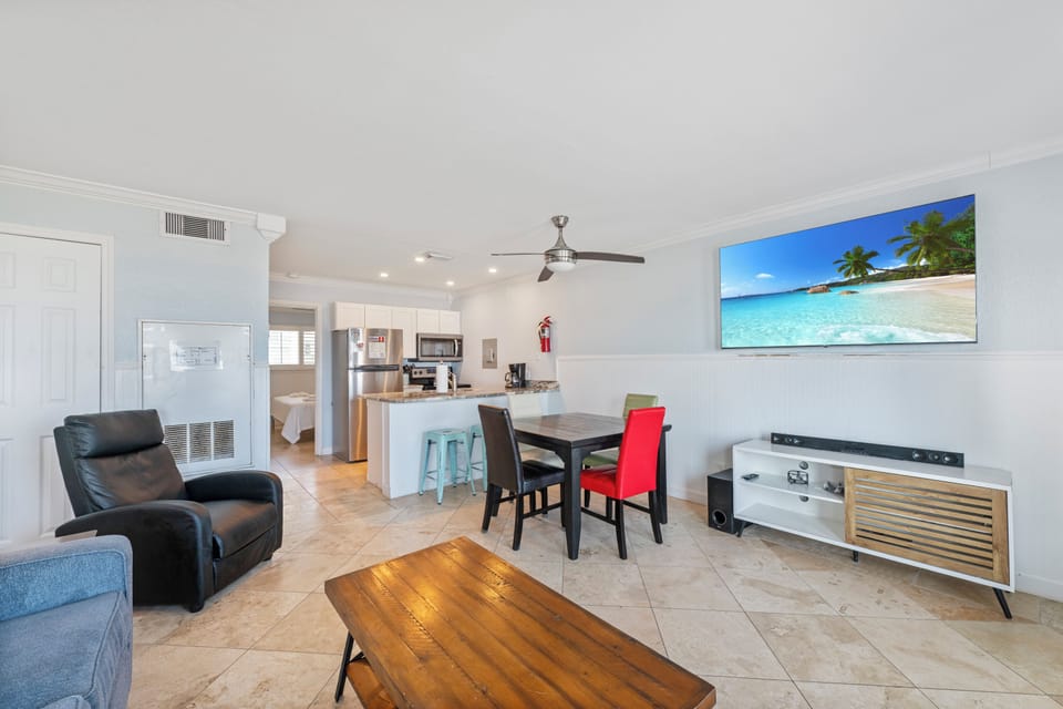 Your bright open-plan living space seamlessly blends comfort and style, with a fully equipped kitchen, dining area, and cozy seating perfect for relaxing.