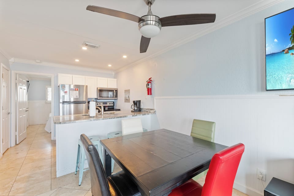 Your open-concept living space features a sleek kitchen and dining area, perfect for preparing meals and gathering together.