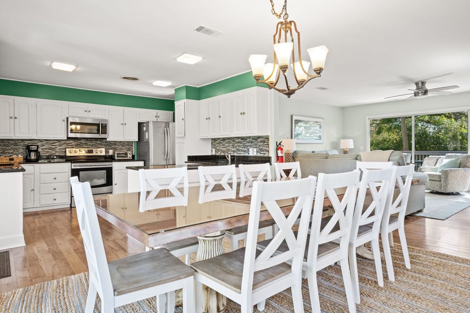 Dining room with seating for 10, slider leading to backyard stairs, open to kitchen and living room