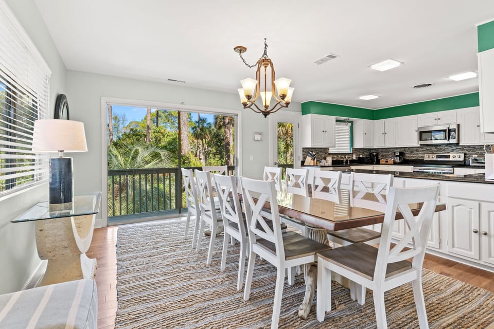 Dining room with seating for 10, slider leading to backyard stairs, open to kitchen and living room