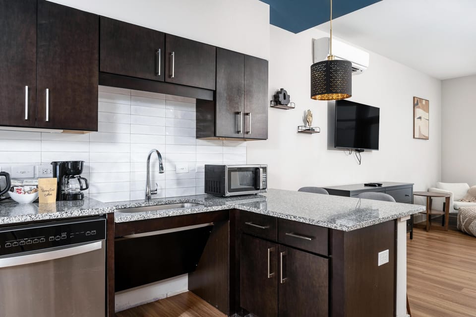 Modern kitchen with sleek dark cabinetry and spacious island