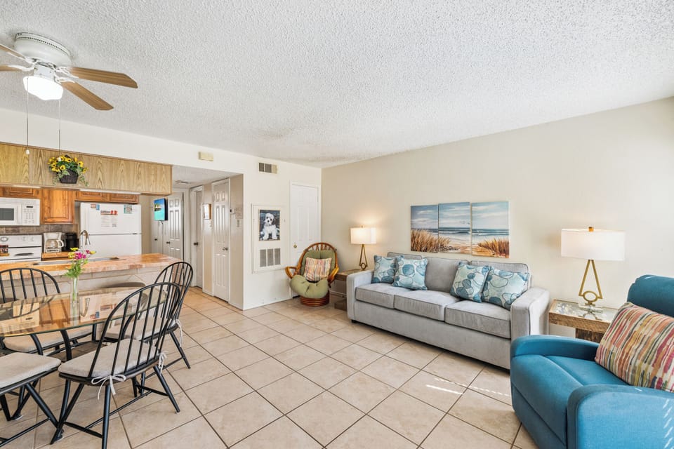 Relax in this bright, open living space with cozy seating and plenty of room to unwind after a day at the beach.