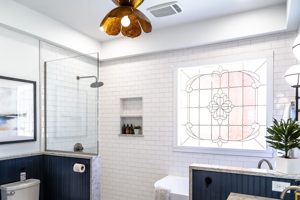 Full Bathroom—This spa-like bathroom boasts heated floors, a towel warmer, a luxurious rain head shower, and a soaking tub.