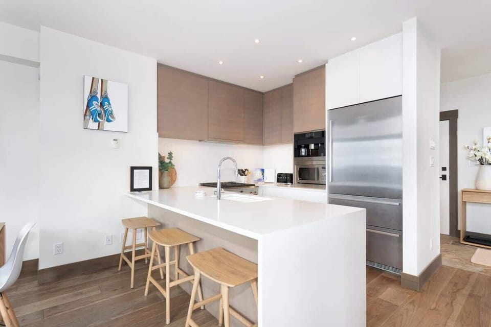 - Modern kitchen with sleek countertops and premium stainless steel appliances  
- Stylish wood cabinets add warmth to the bright and airy cooking space  
- Perfect for preparing hearty breakfasts before hitting the slopes  
