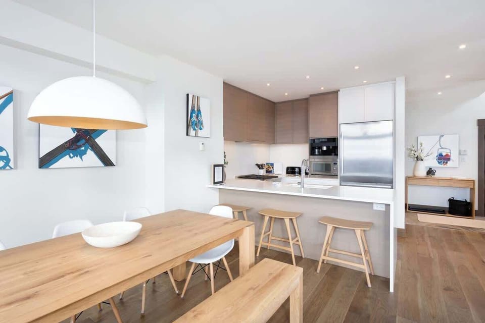 - Kitchen and dining seamlessly connected for an airy open flow  
- Bar seating and soft lighting create a warm and welcoming atmosphere  
- Perfect for cooking, dining, and entertaining with mountain views  
