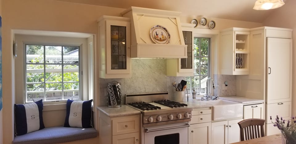 Viking gas stove/oven with kitchen windowseat and 6.5 foot country pine table
