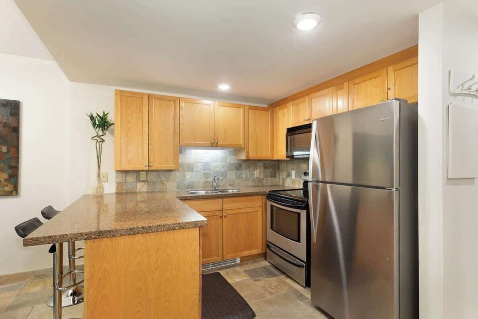 - Fully equipped kitchen with granite counters and modern stainless design  
- Cook gourmet meals steps from slopes in this cozy Whistler suite  
- Perfect mountain getaway with open kitchen for relaxing dinners  