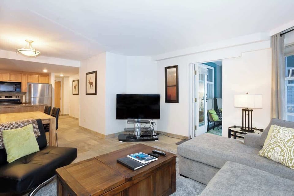 - Spacious living room with smart TV and access to private forest patio  
- Relax after skiing in open-concept comfort and mountain-inspired decor  
- Ideal for families seeking cozy luxury near Whistler slopes and trails  
