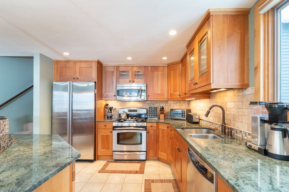 Stainless steel oven, microwave, and fridge of the kitchen.