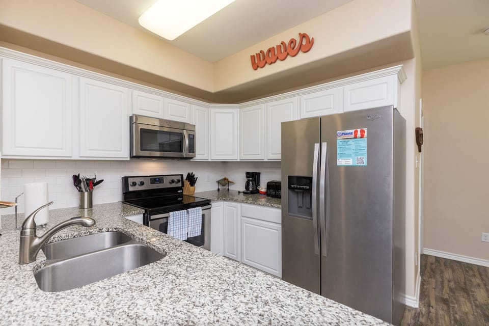 Your fully equipped kitchen features granite countertops, stainless steel appliances, and everything you need to prepare delicious meals during your stay.