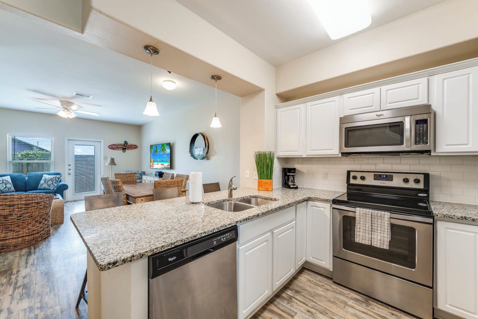 Your modern kitchen invites culinary adventures with granite countertops, stainless steel appliances, and an open layout flowing seamlessly into your dining and living spaces.