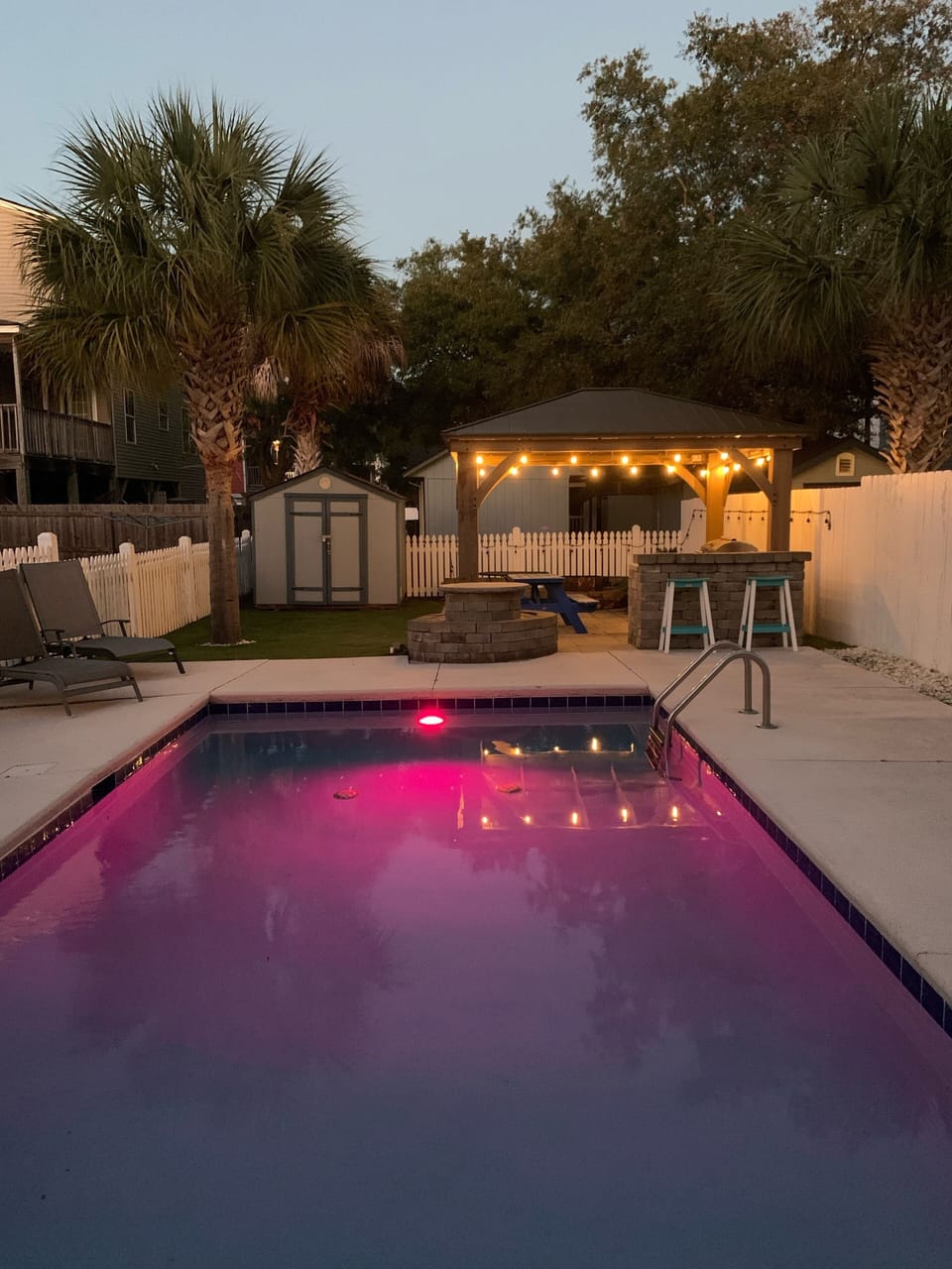 Evenings by the pool under the lights — relax after a beach day.