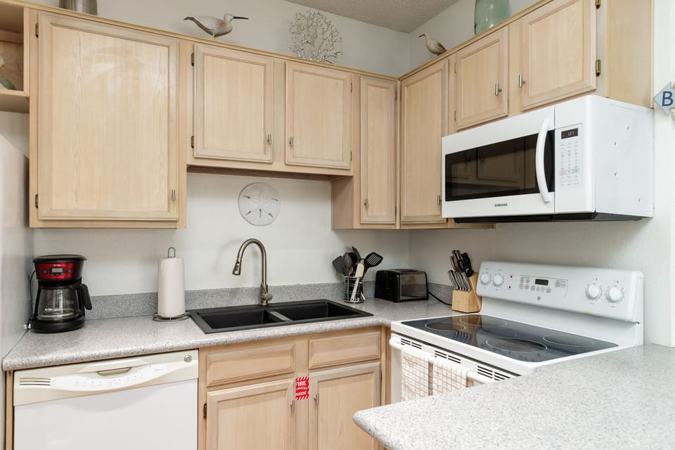 Your fully-equipped kitchen awaits with modern appliances and ample cabinet space for preparing home-cooked meals during your stay.