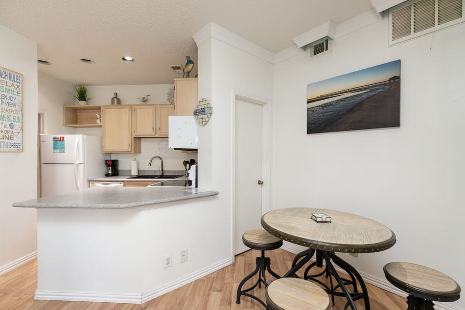Your bright kitchen flows into a cozy dining space where you'll savor morning coffee and plan beach adventures.