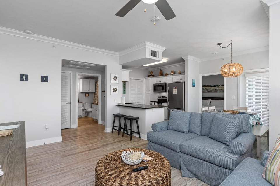 Relax in your spacious open-plan retreat with comfortable seating, modern kitchen, and coastal-inspired touches throughout your bright vacation home.