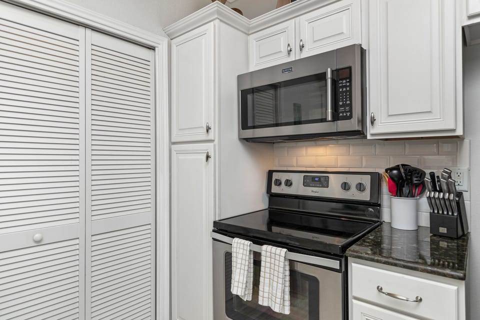 Your fully equipped kitchen awaits with sleek stainless steel appliances and granite countertops, perfect for creating memorable meals during your stay.