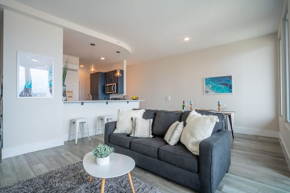 Decor is modern coastal with macrame touches & a neutral grey and sand palette.