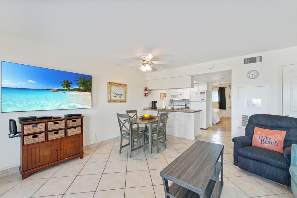 Relax in your bright, open-concept space with tropical vibes, complete kitchen, and beach-themed touches that invite you to unwind.