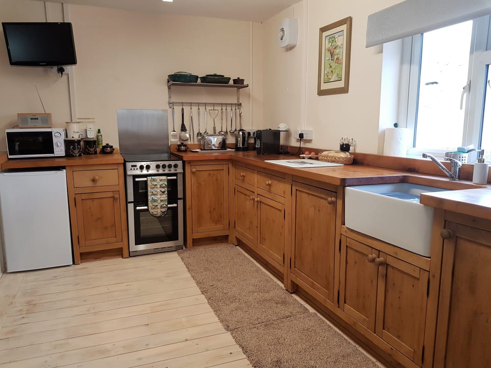 Large hand-crafted well-equipped kitchen with quality crockery and Belfast sink.