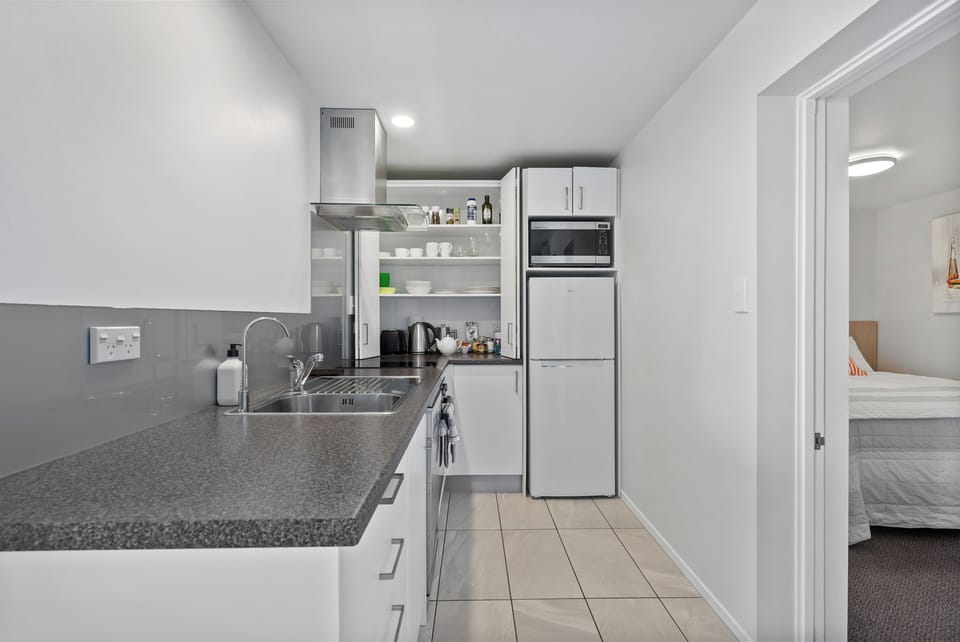Kitchen with full size oven, microwave, fridge, induction hob, and dishwasher!